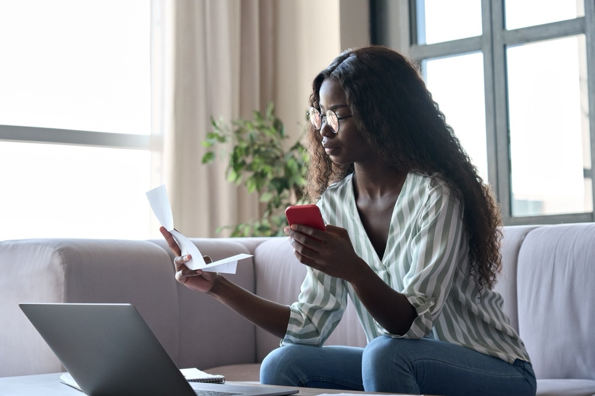 woman looking at receipts