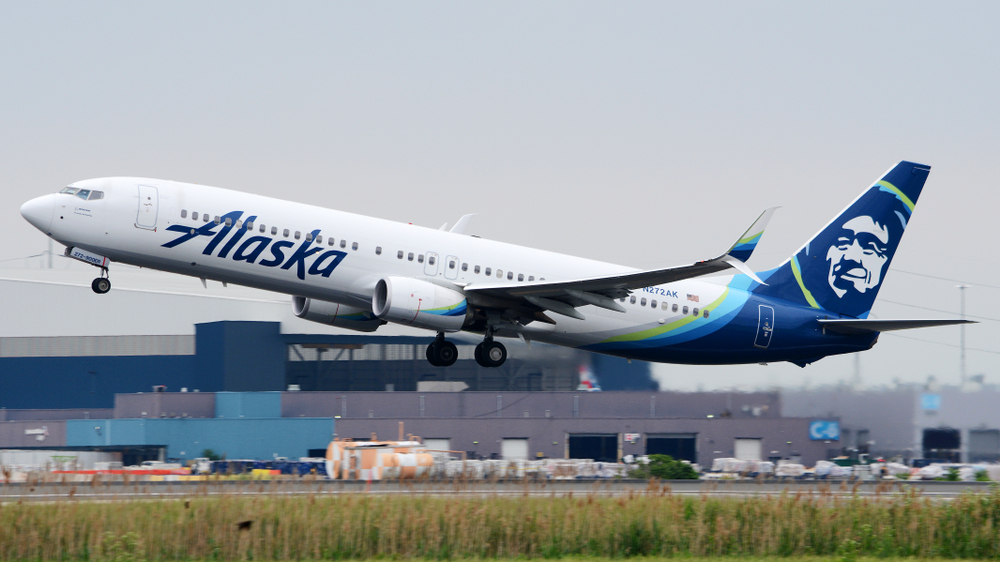 An Alaska Airlines plane taking off from an airport