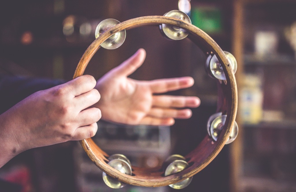 person playing a tambourine