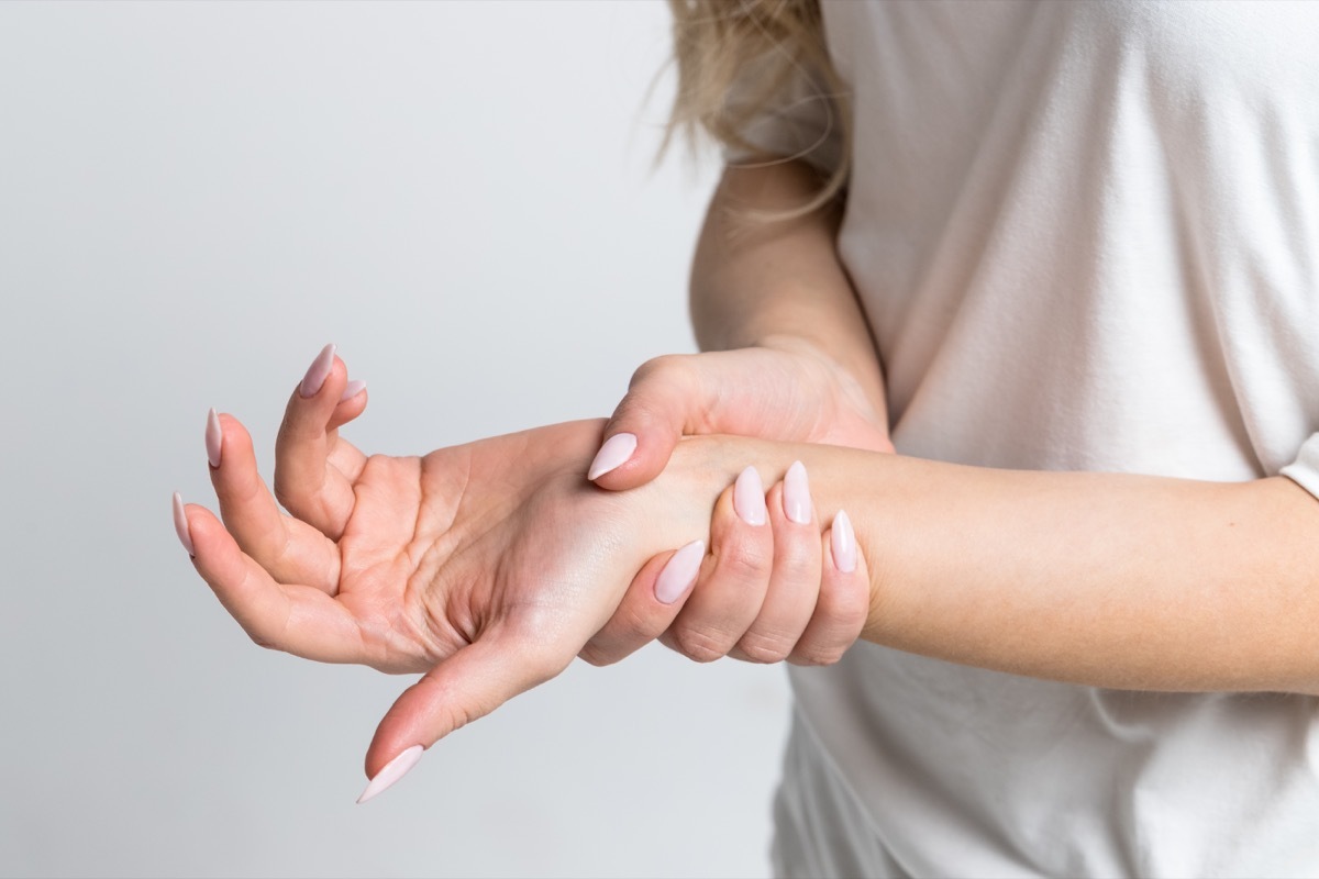 Woman holding her wrist