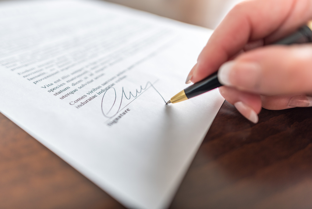 woman signing a contract