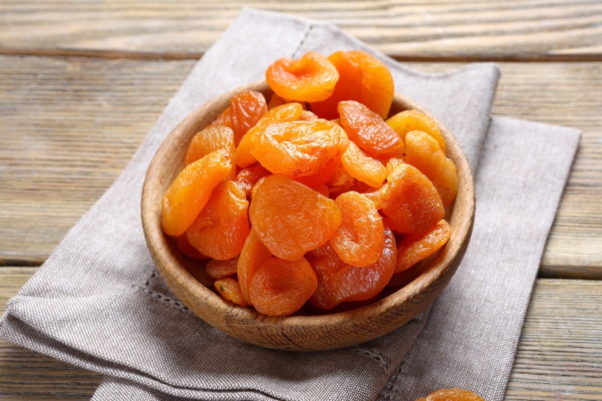 Delicious dried apricots in a bowl on napkin, food