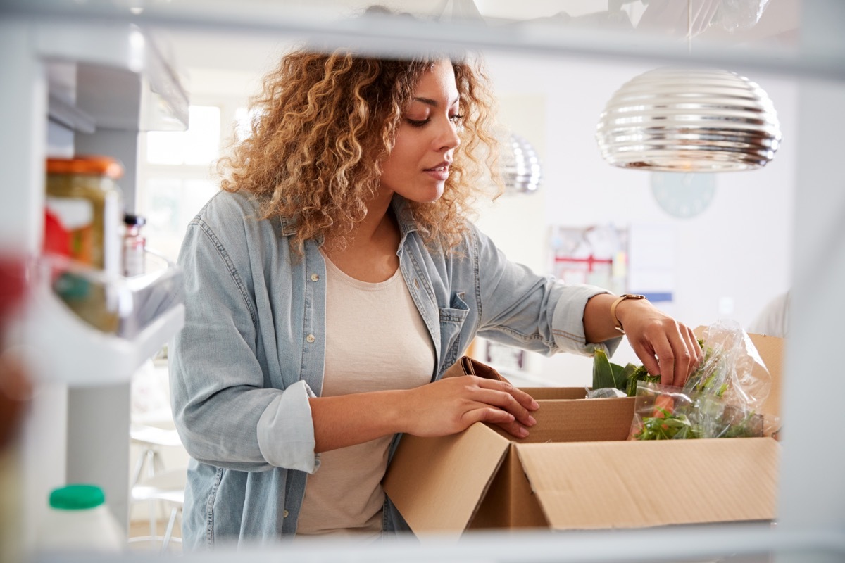 Woman opening food delivery box