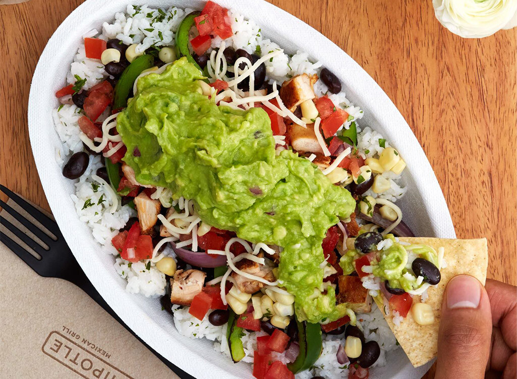 Chip dipping into chipotle chicken burrito bowl