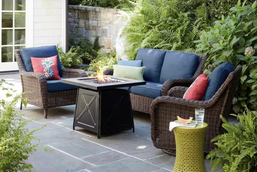 chairs and fire pit table on a patio outside