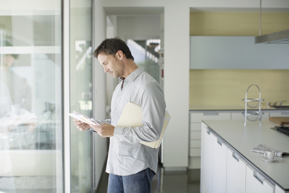 Man sorting mail at home