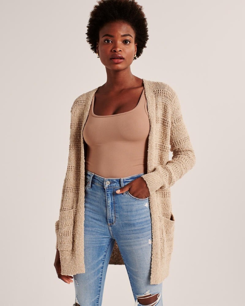 young black woman in open camel colored cardigan