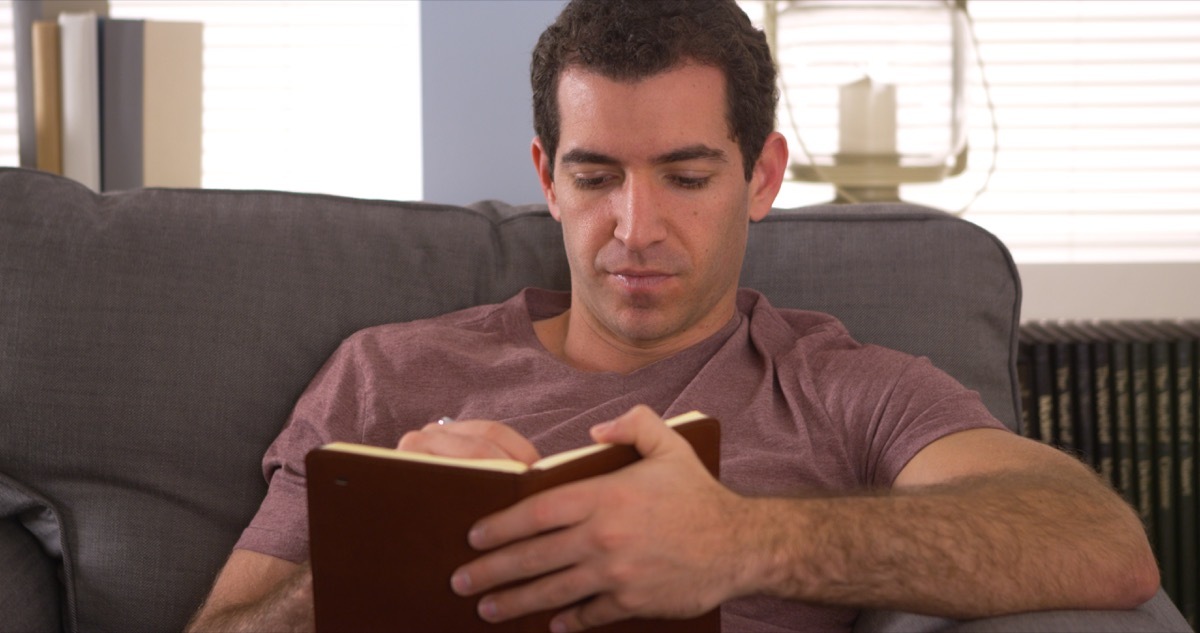 Man writing in journal