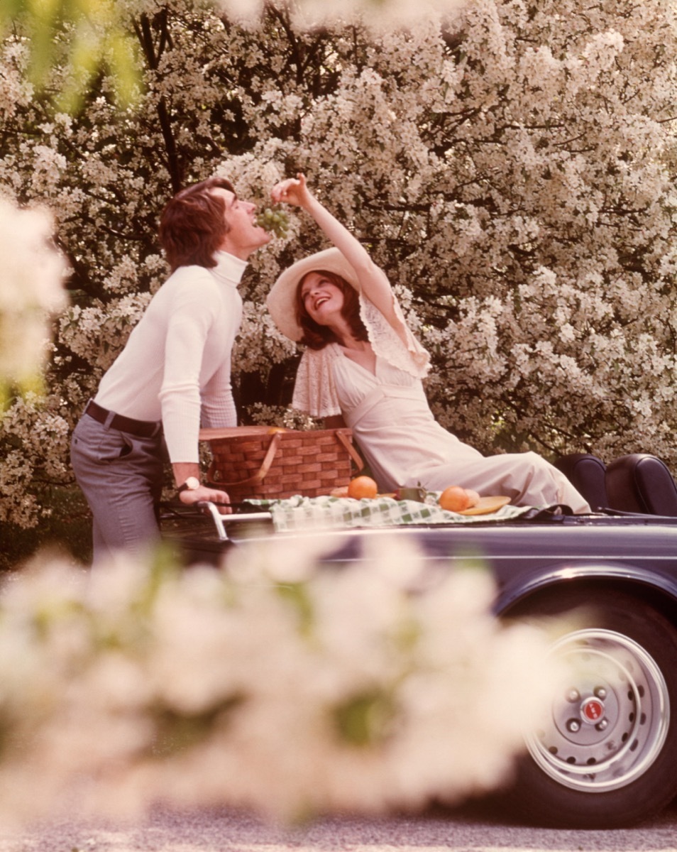 A 1970s Couple Having a Picnic on Their Car How People Used to Flirt