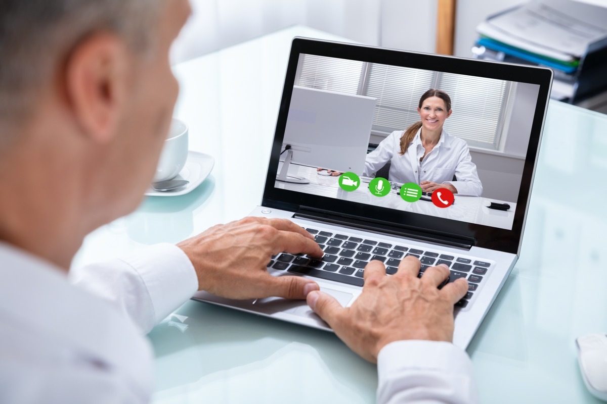 Videoconferencing With Happy Female Doctor On Laptop