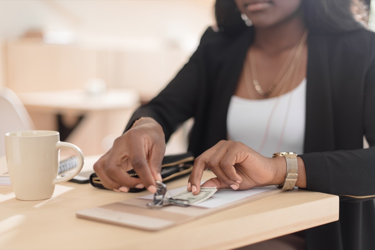 woman tipping in cash