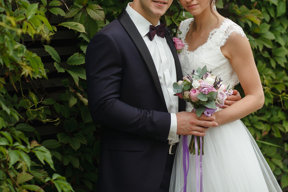 groom holding bride around waist