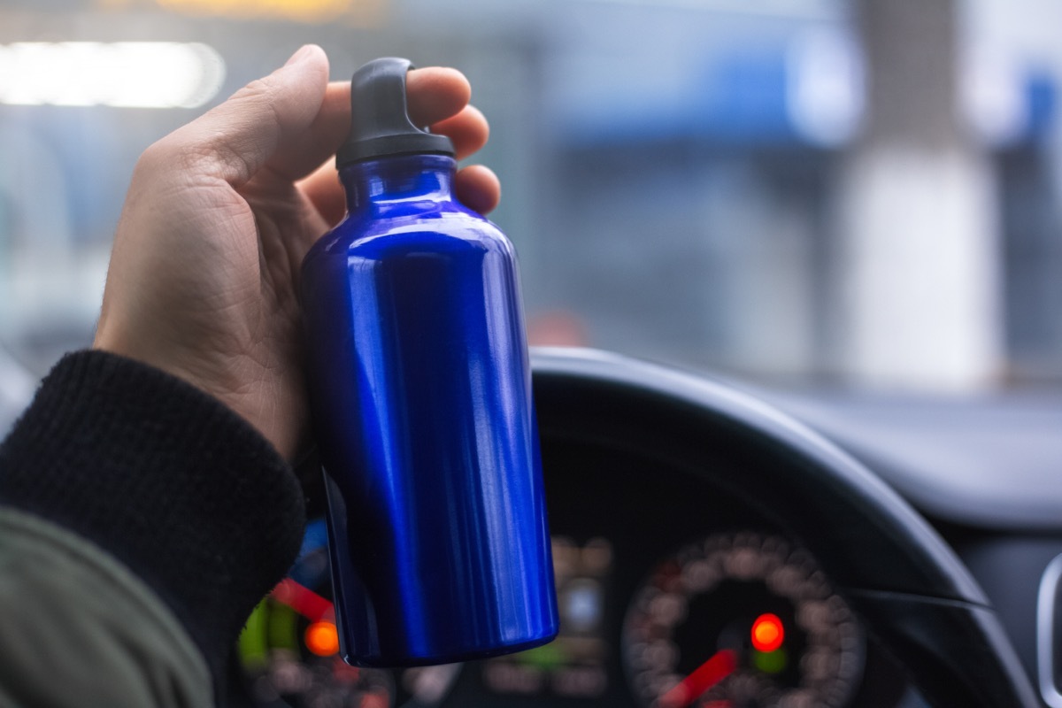 hand holding stainless steel bottle