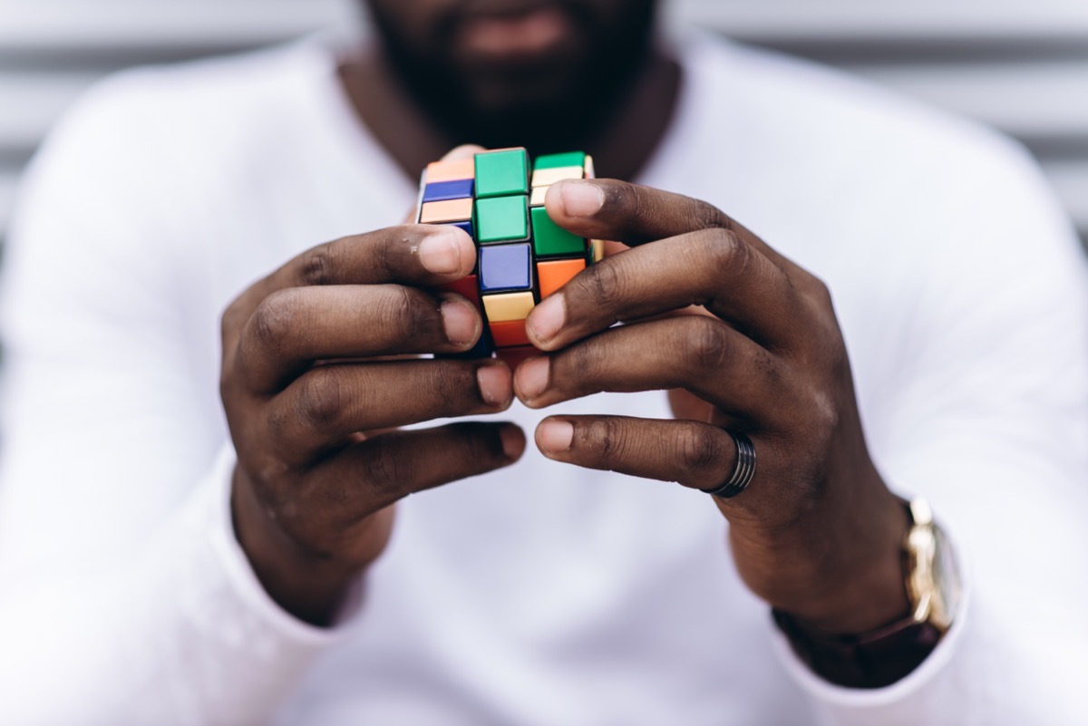 man solving a rubiks cube