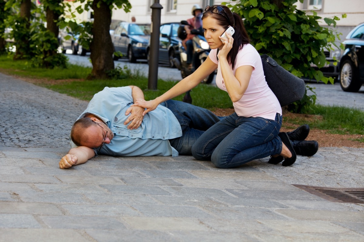  man has a dizzy spell or a heart attack. Woman comes to the rescue