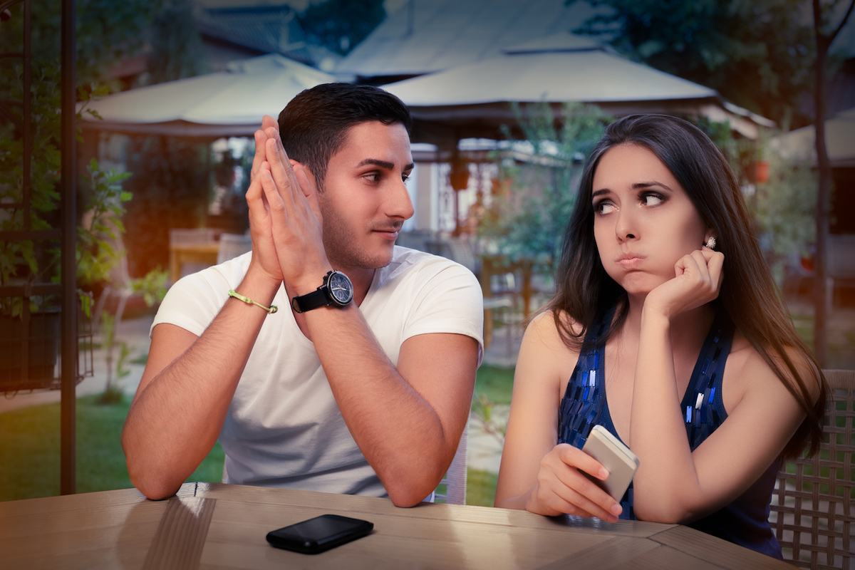 man says something that makes woman roll her eyes at bar