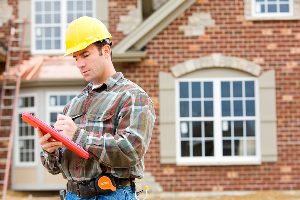 Architect Checking Insulation During House Construction