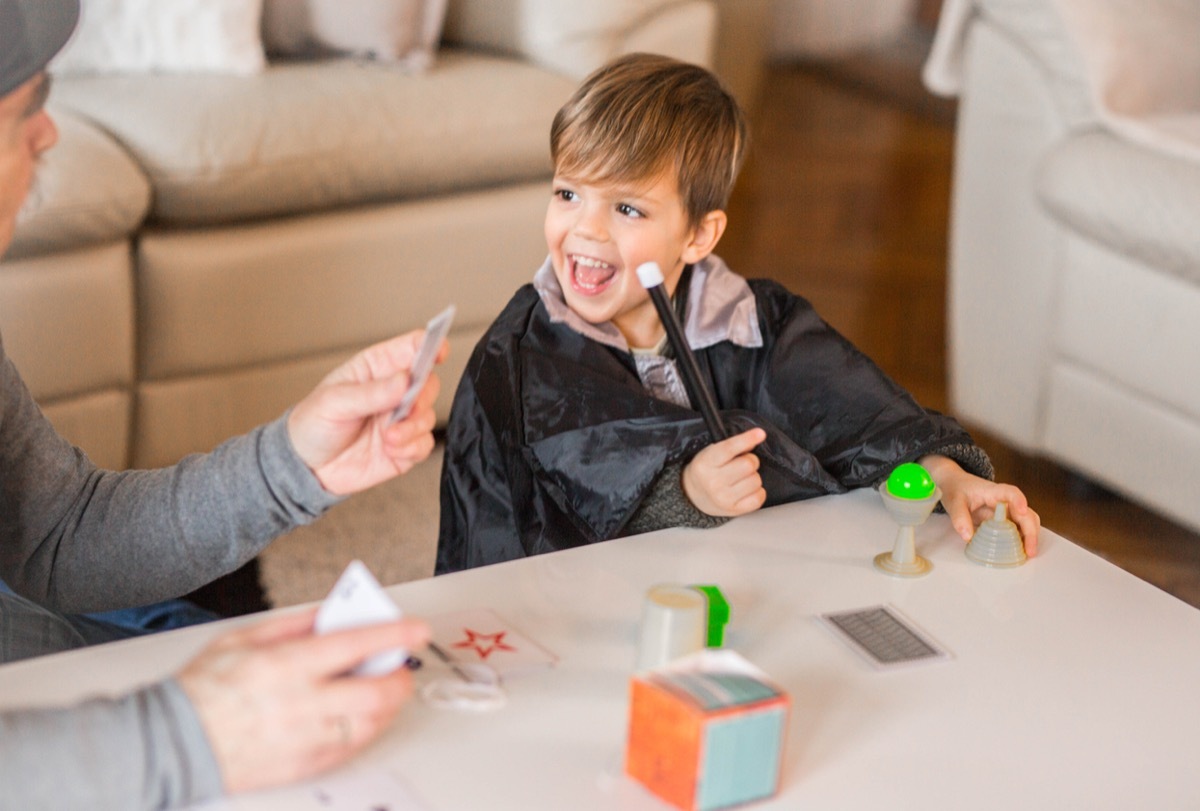 Grandfather doing magic trick with his grandson