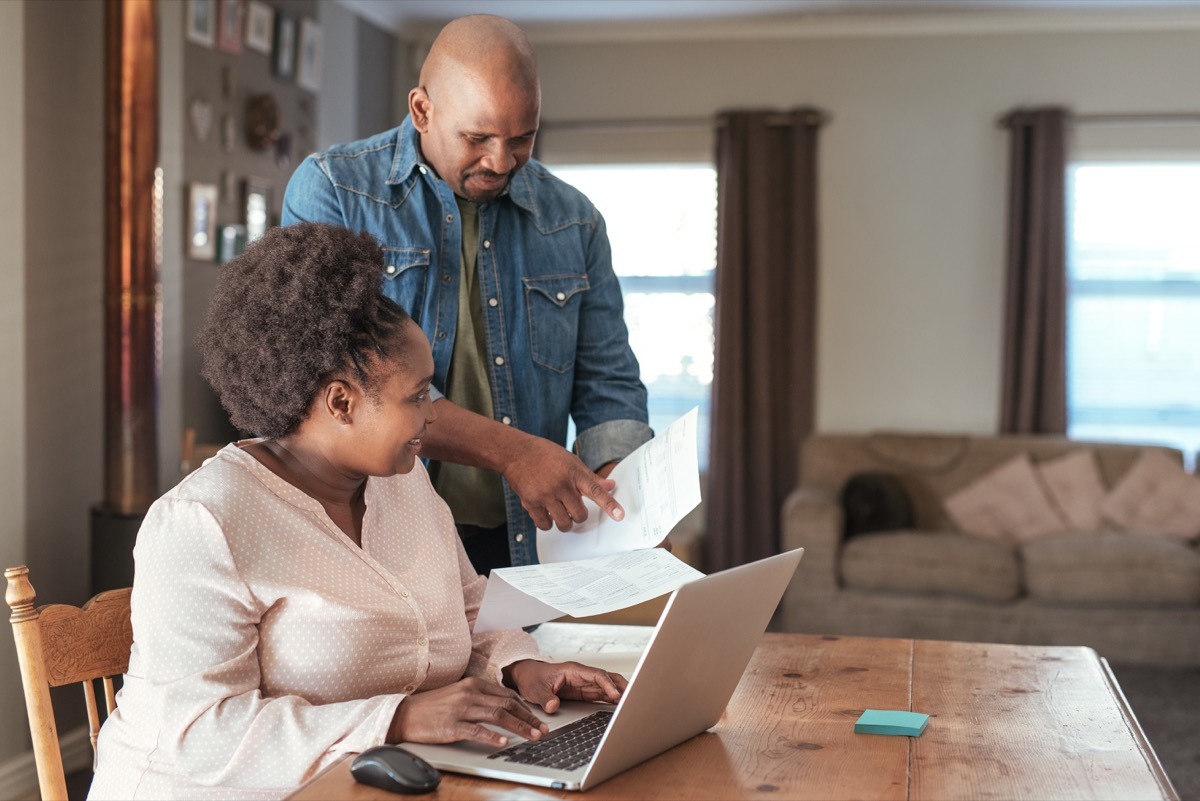 couple looking over paperwork together, better husband