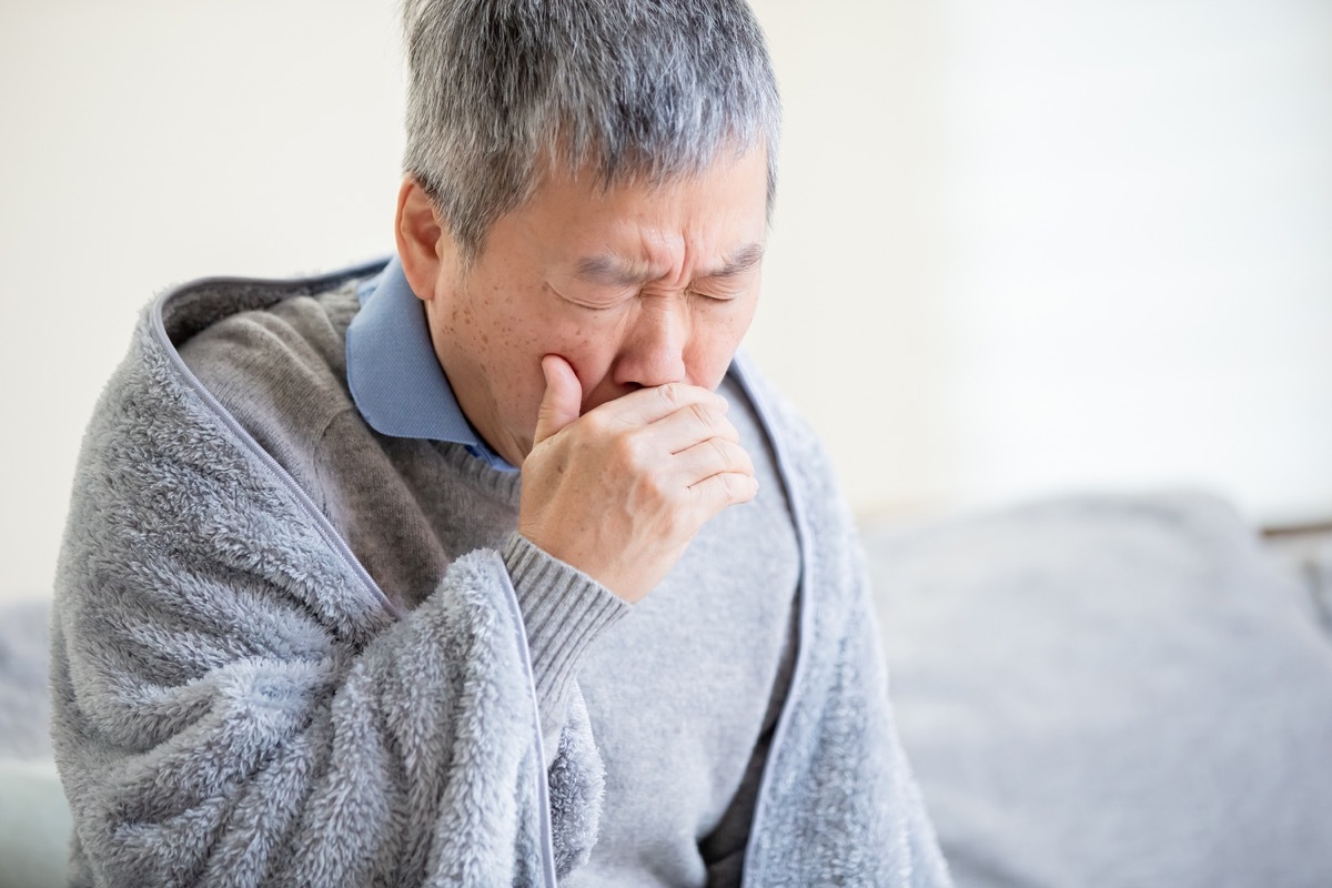 elderly sick man has a cold and cough at home