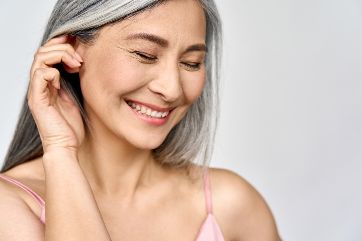 Portrait of gorgeous happy woman with gray hair.