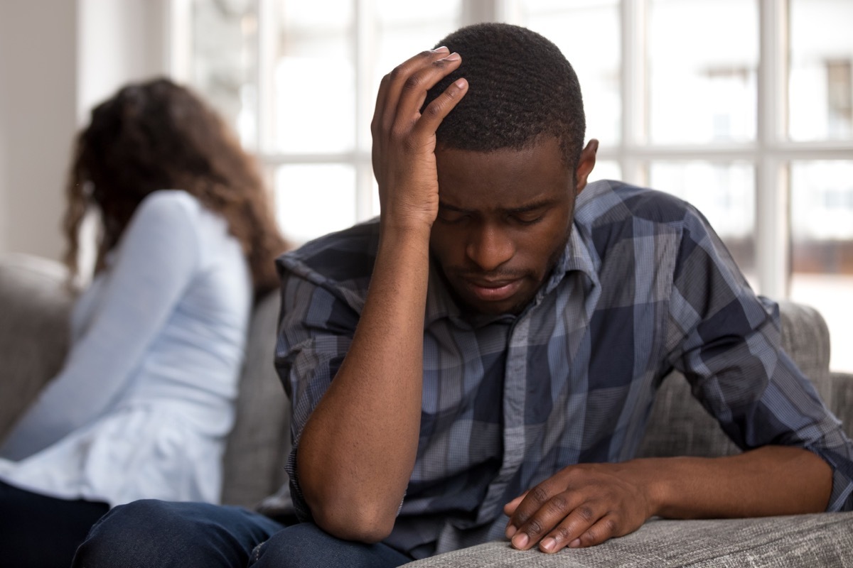 A Man wearing a blue plaid shirt is upset with his wife 