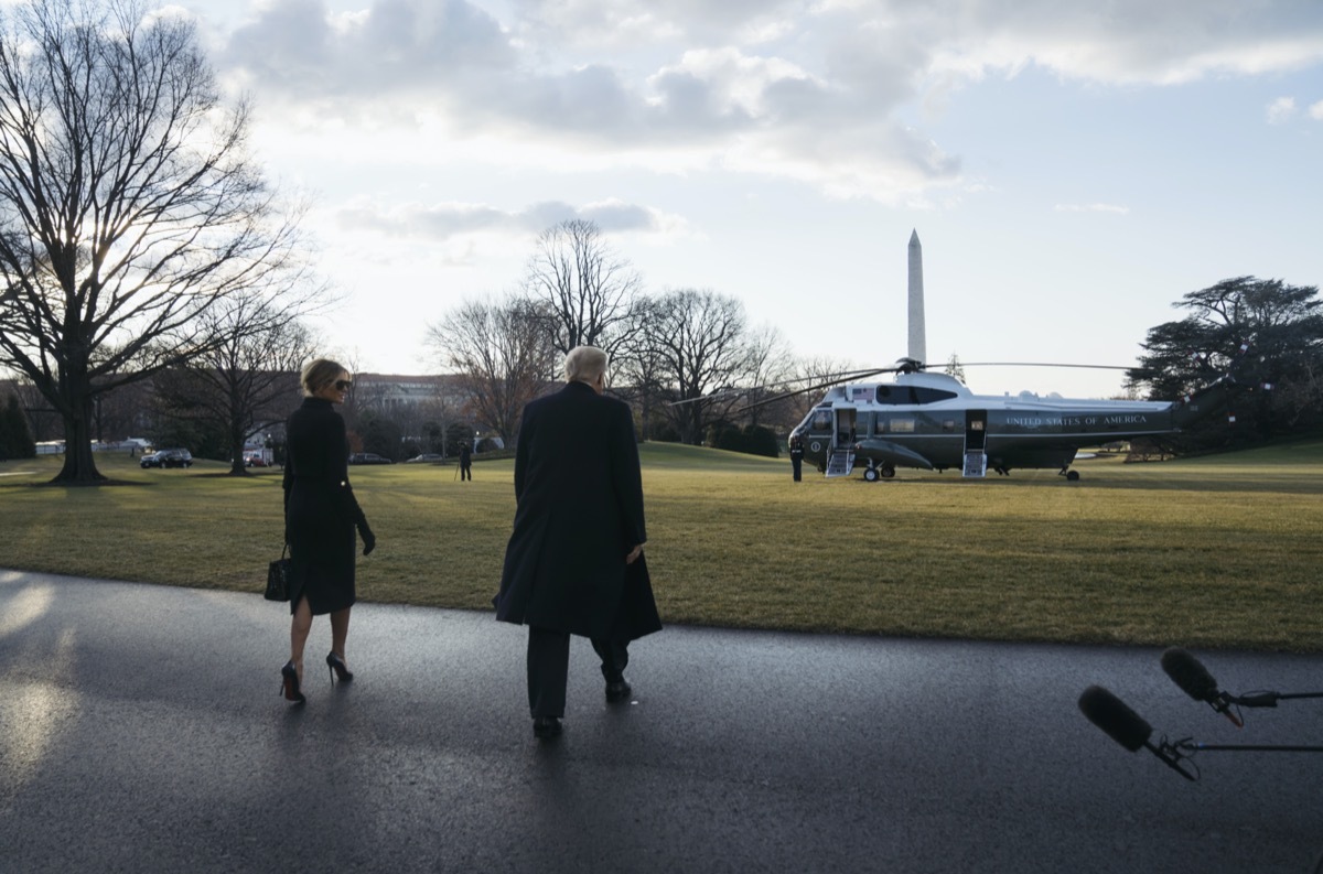 donald and melania trump walk toward marine one helicopter