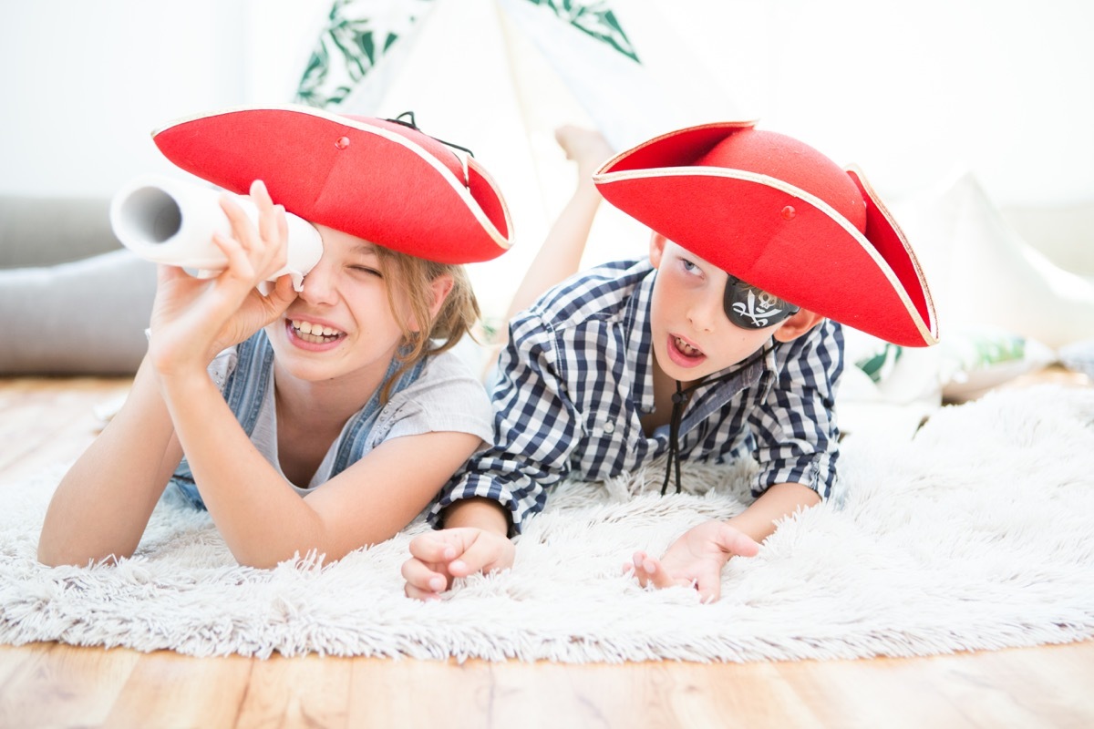 young brother and sister playing pirates