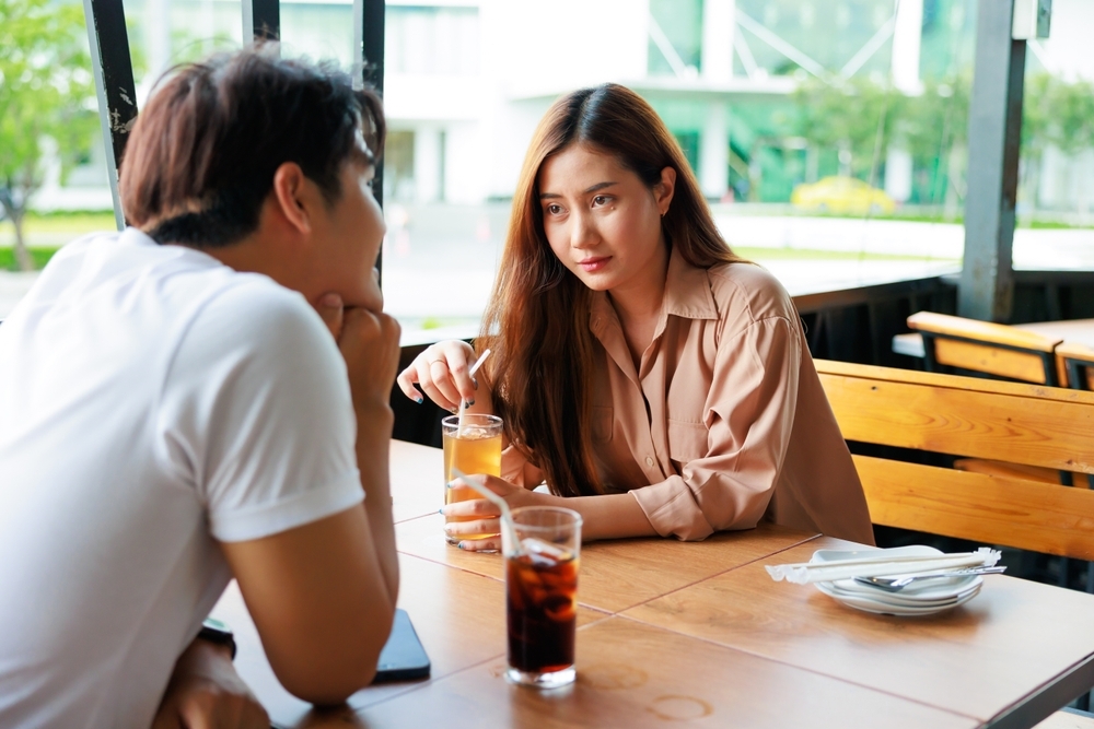 Young Asian woman on date with boyfriend