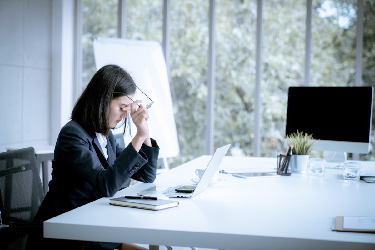 stressed out asian woman at work