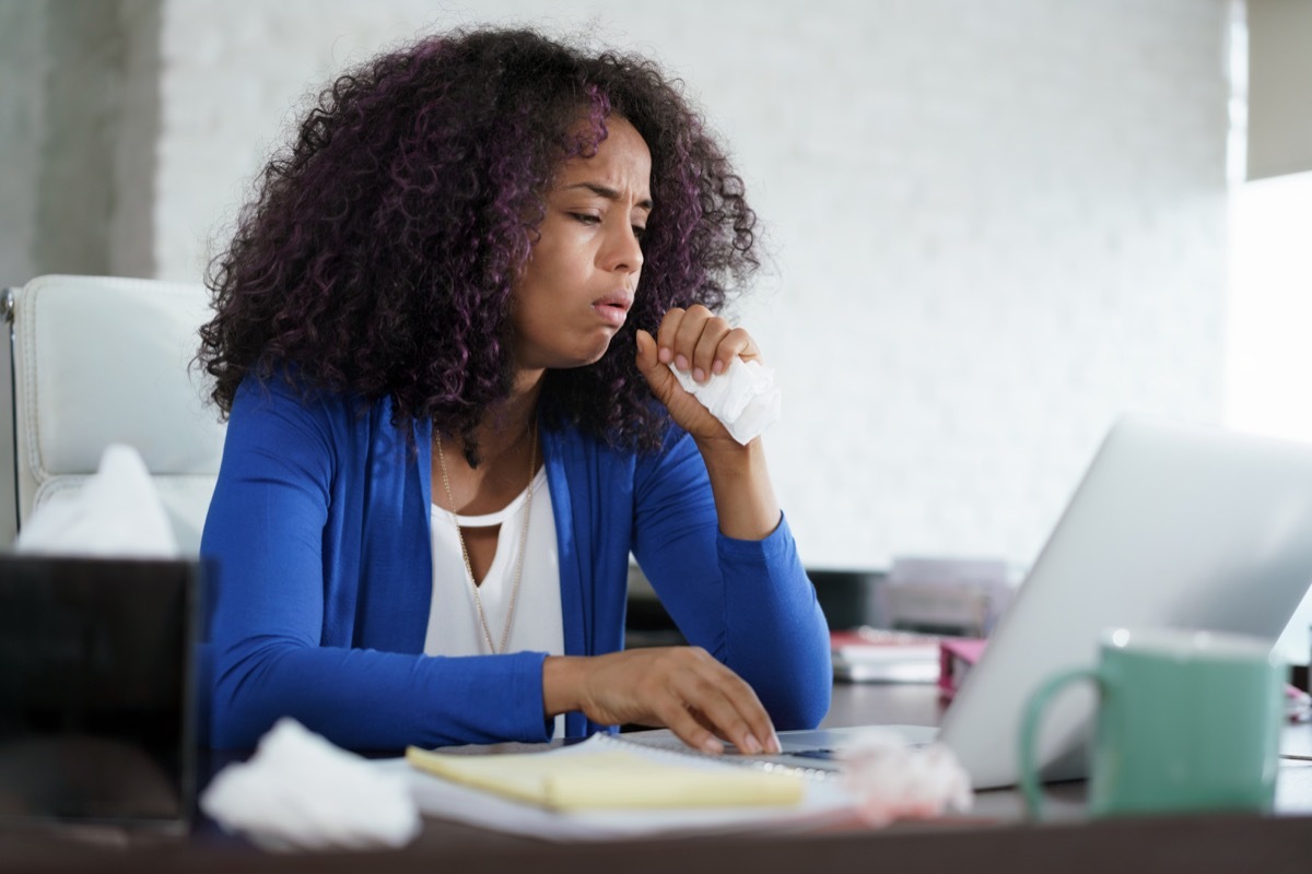 Woman Working At Home Coughing And Sneezing