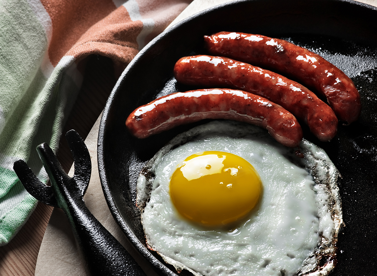 fried egg and sausage links in pan