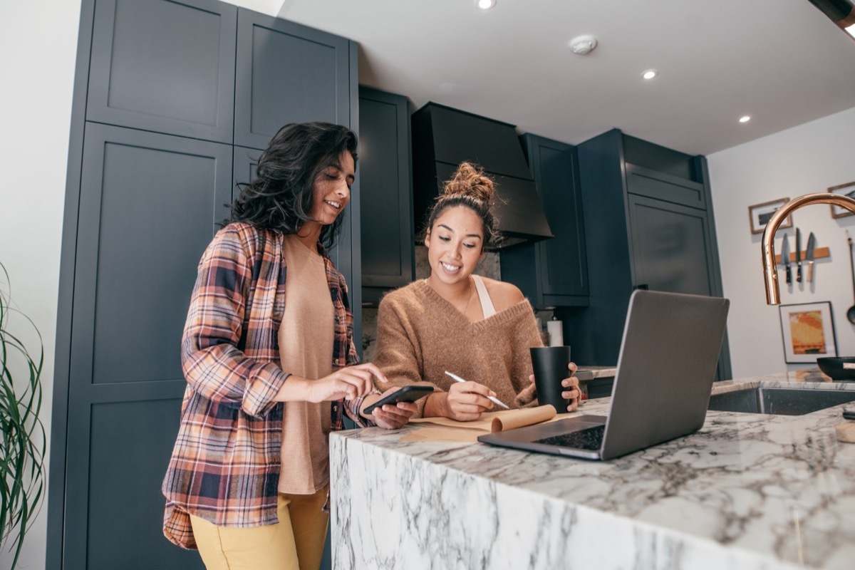 Two young students sitting on the kitchen, They are vlooging and preparing the meal