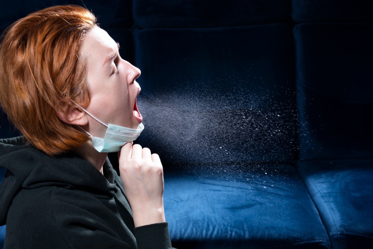 Woman sneezing.