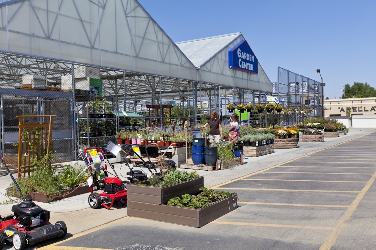 Bountiful, Utah, USA - September 7, 2011: Two women look at the raised garden plants at Lowes in Bountiful, Utah on a fall day. One of the women is holding a baby.