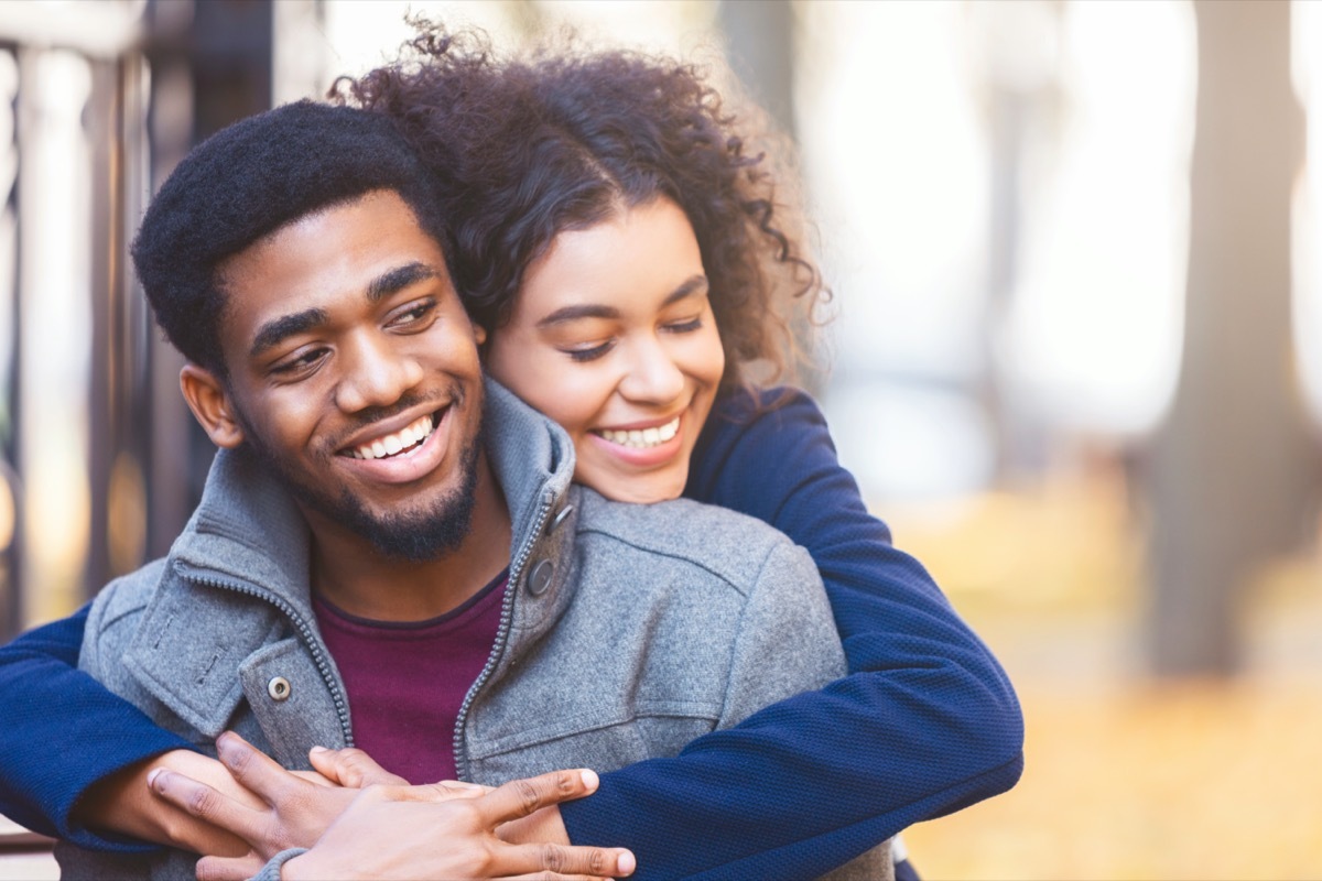 Young couple hugging in a park in the fall