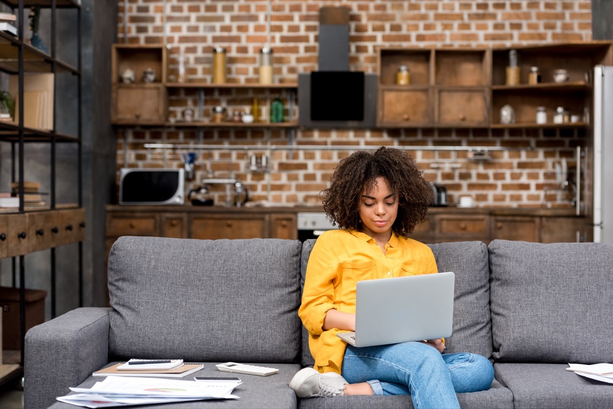 Woman working on her couch