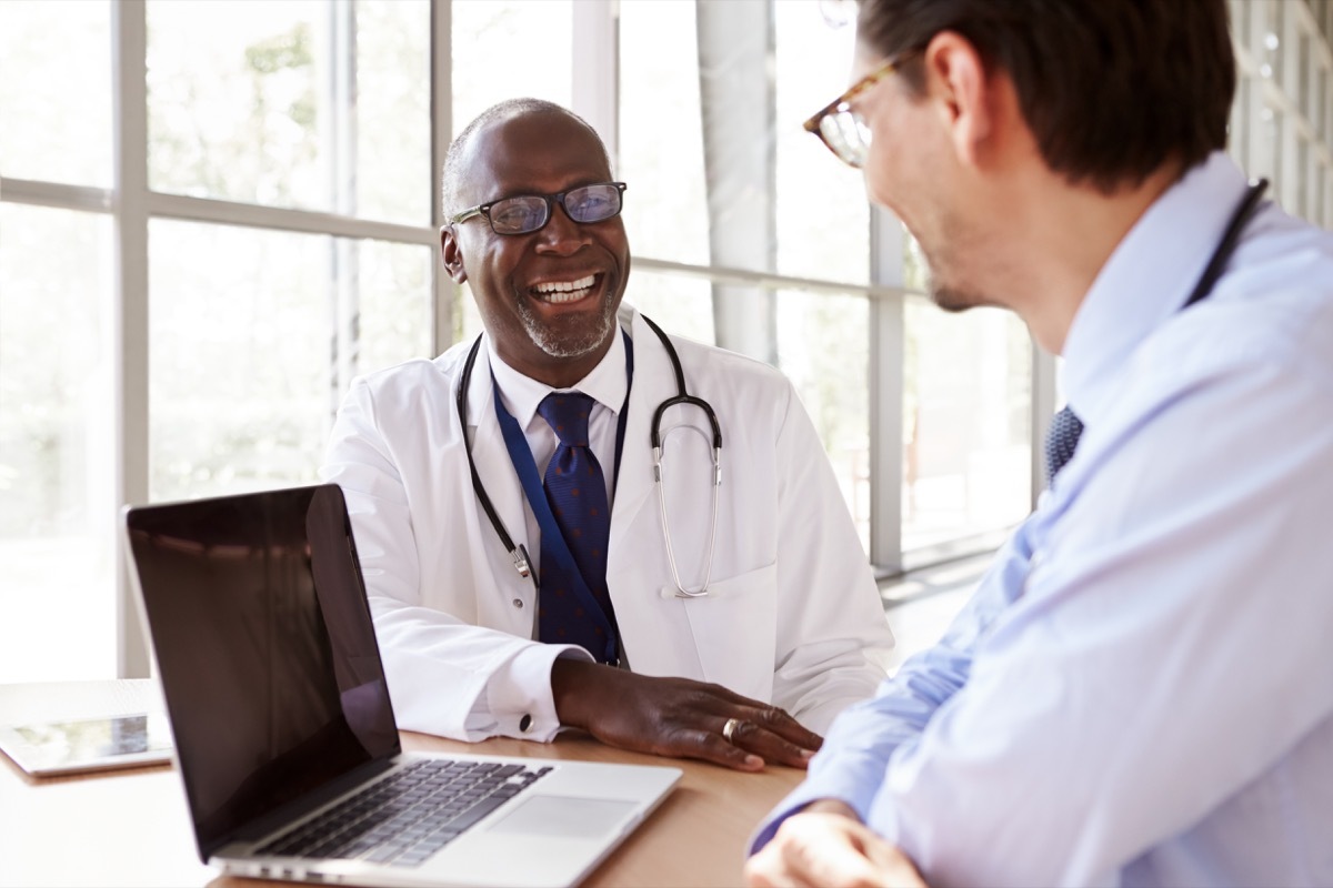 Two senior healthcare workers in consultation laughing