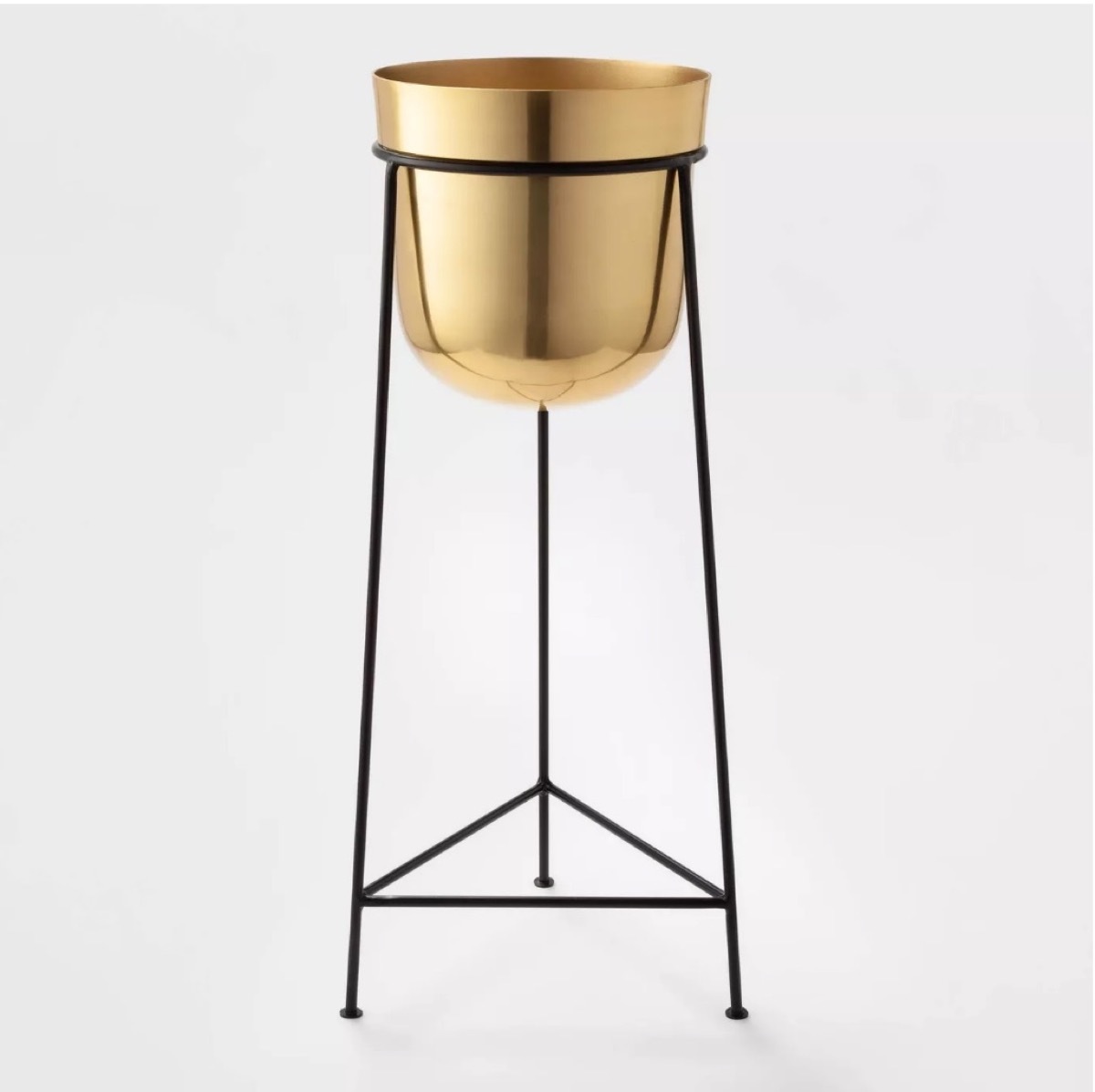 brass bucket plant stand on black legs