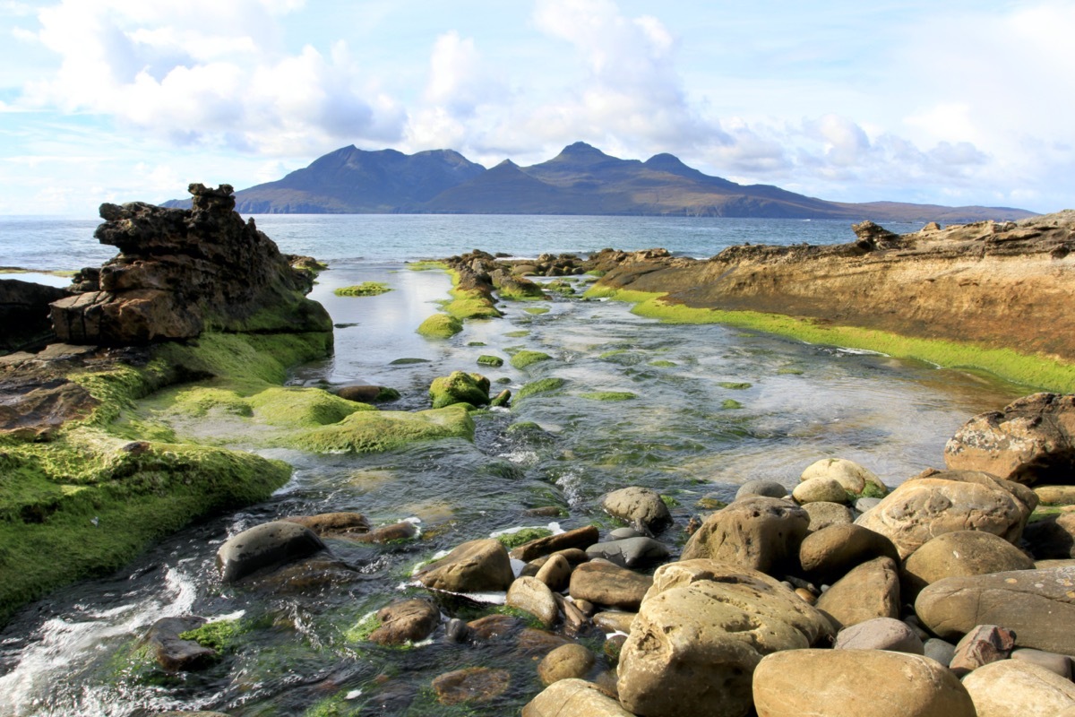 view of isle of rum in the distance over the water