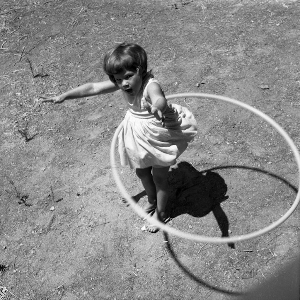 little girl using a hula hoop in the 1950s