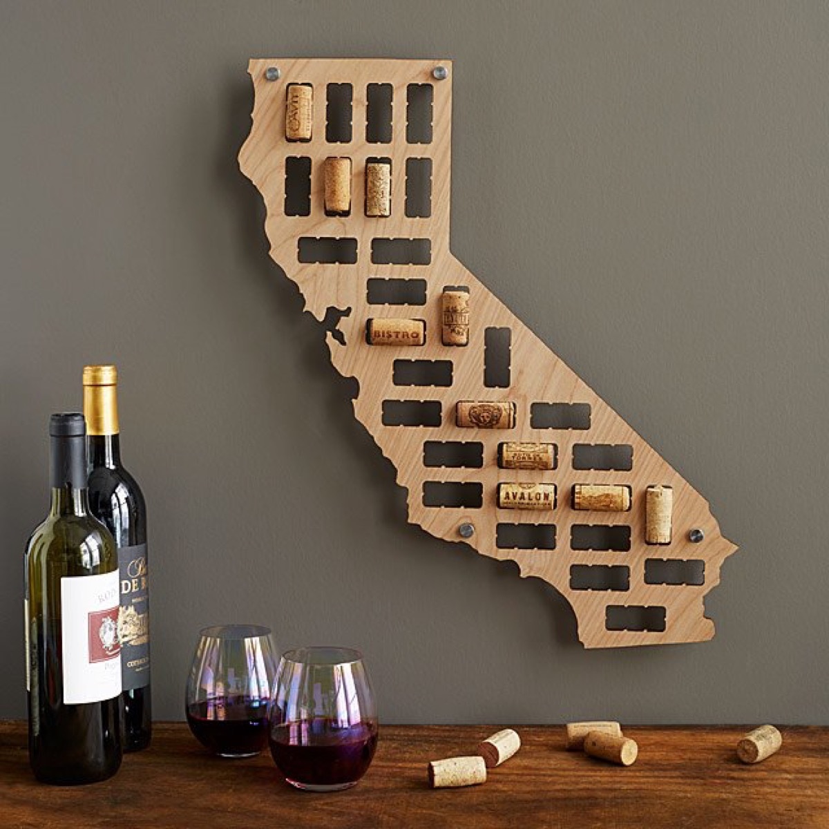 wooden map of california with wine corks in it