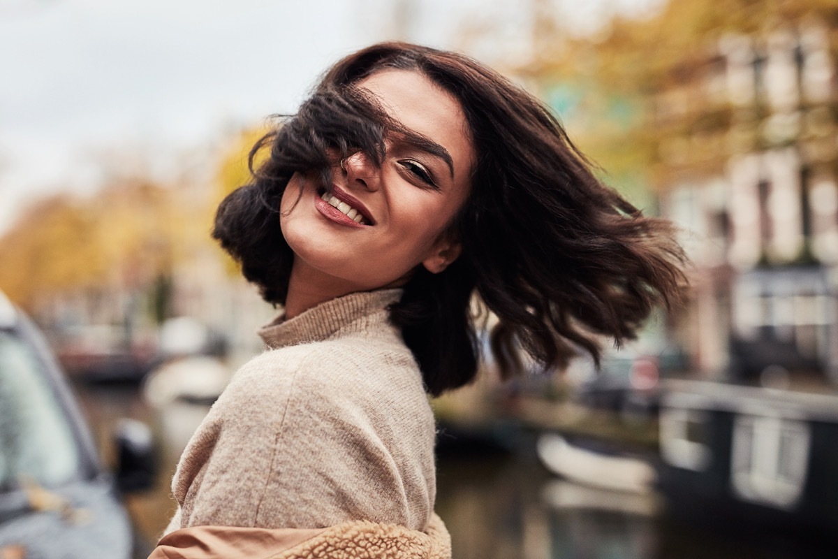 Girl With Short Brown Hair Blowing Outside