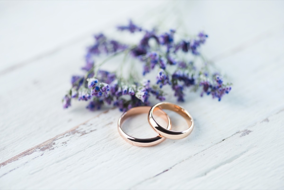 Wedding rings with lavender on table