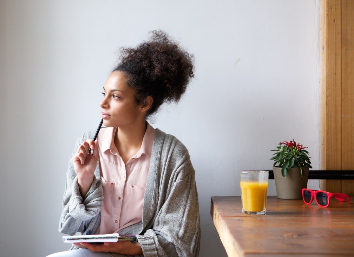 woman looking out the window pensively