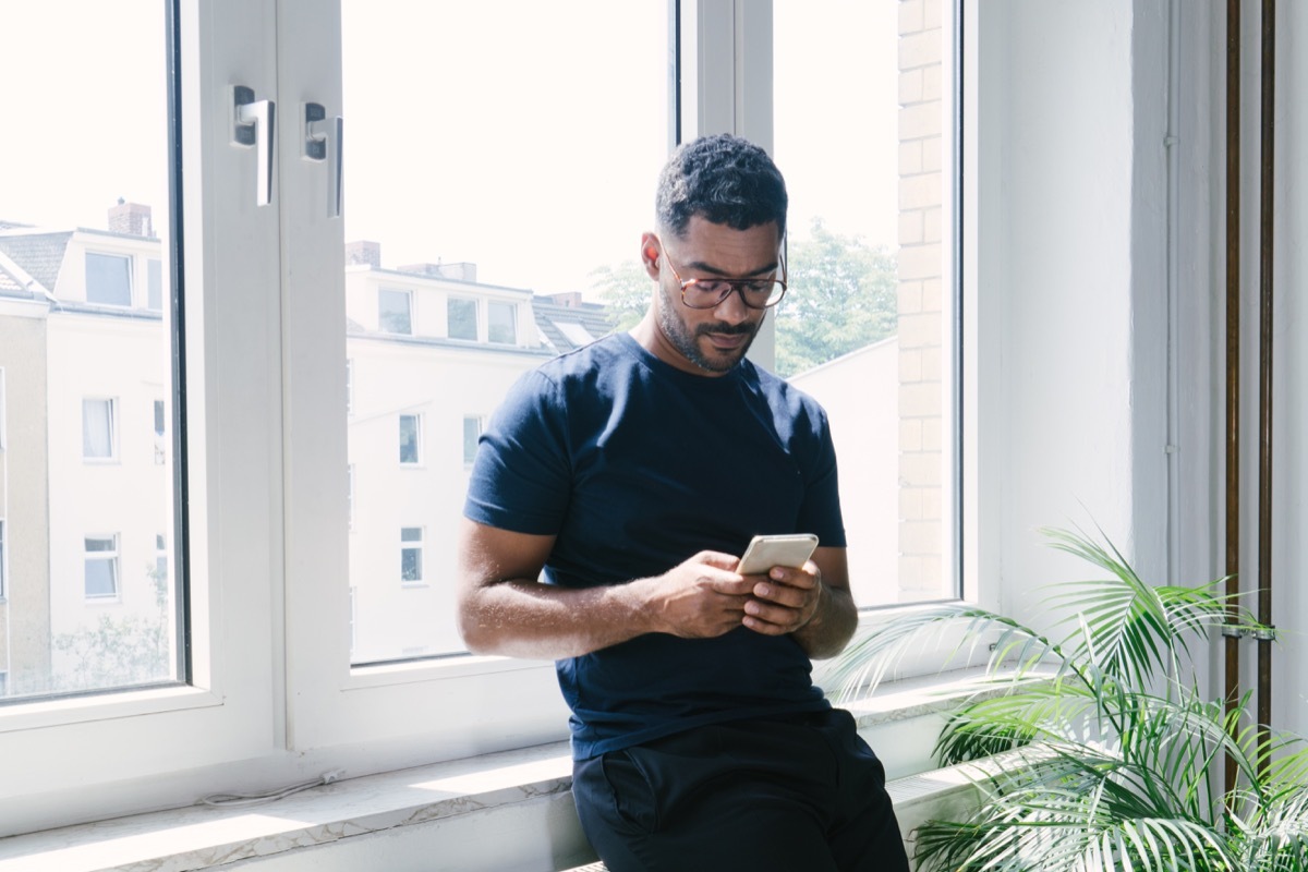 Portrait of a young man on the phone indoors