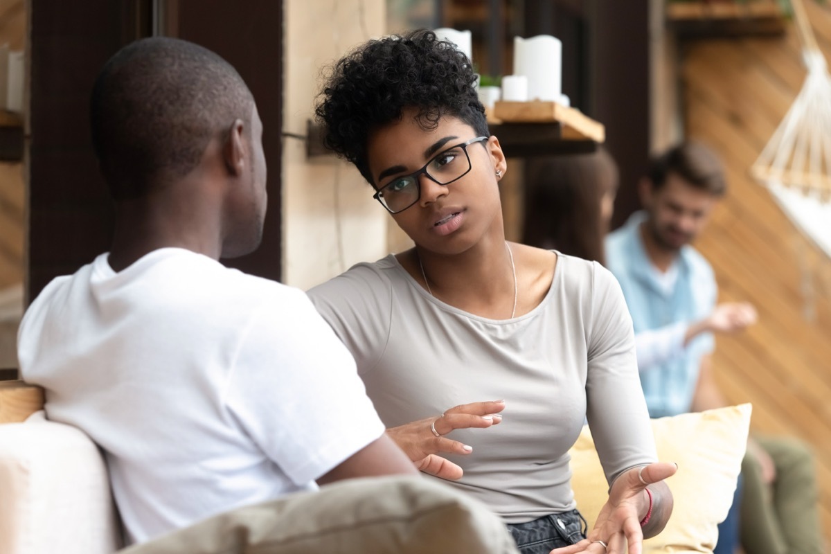 black man and woman talking outdoors