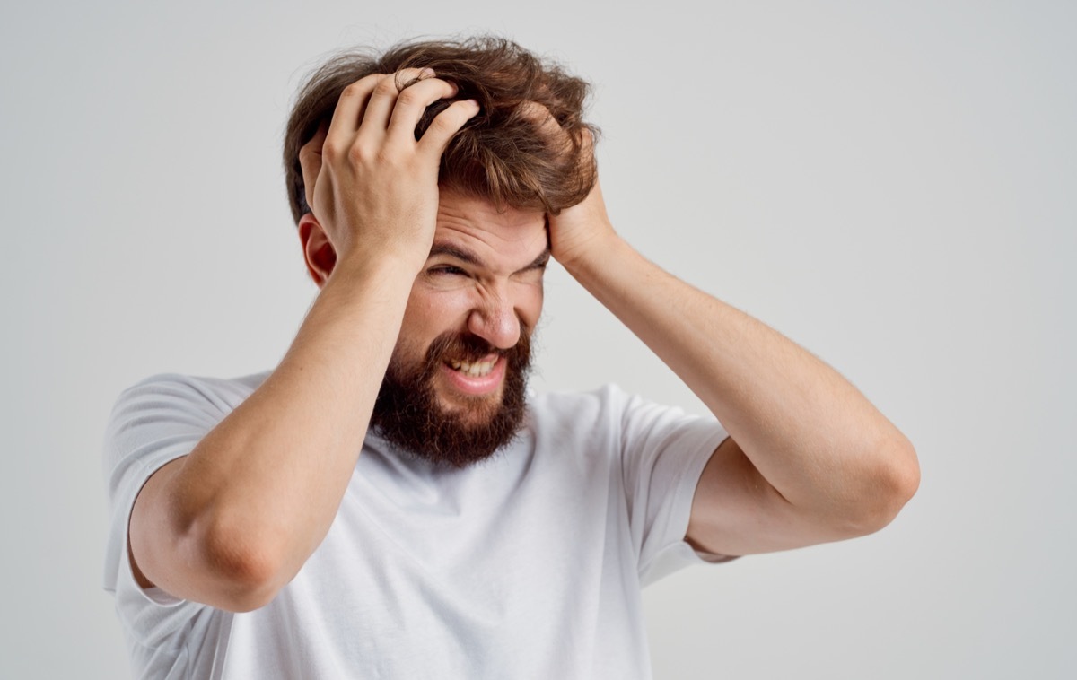 Man Grabbing His Head in Frustration