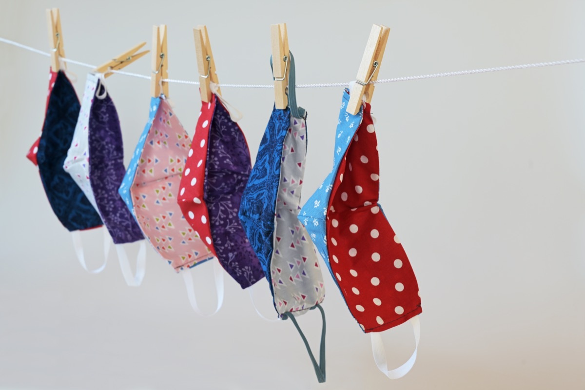 Homemade community face masks from colorful cotton against coronavirus pandemic hanging on a clothesline