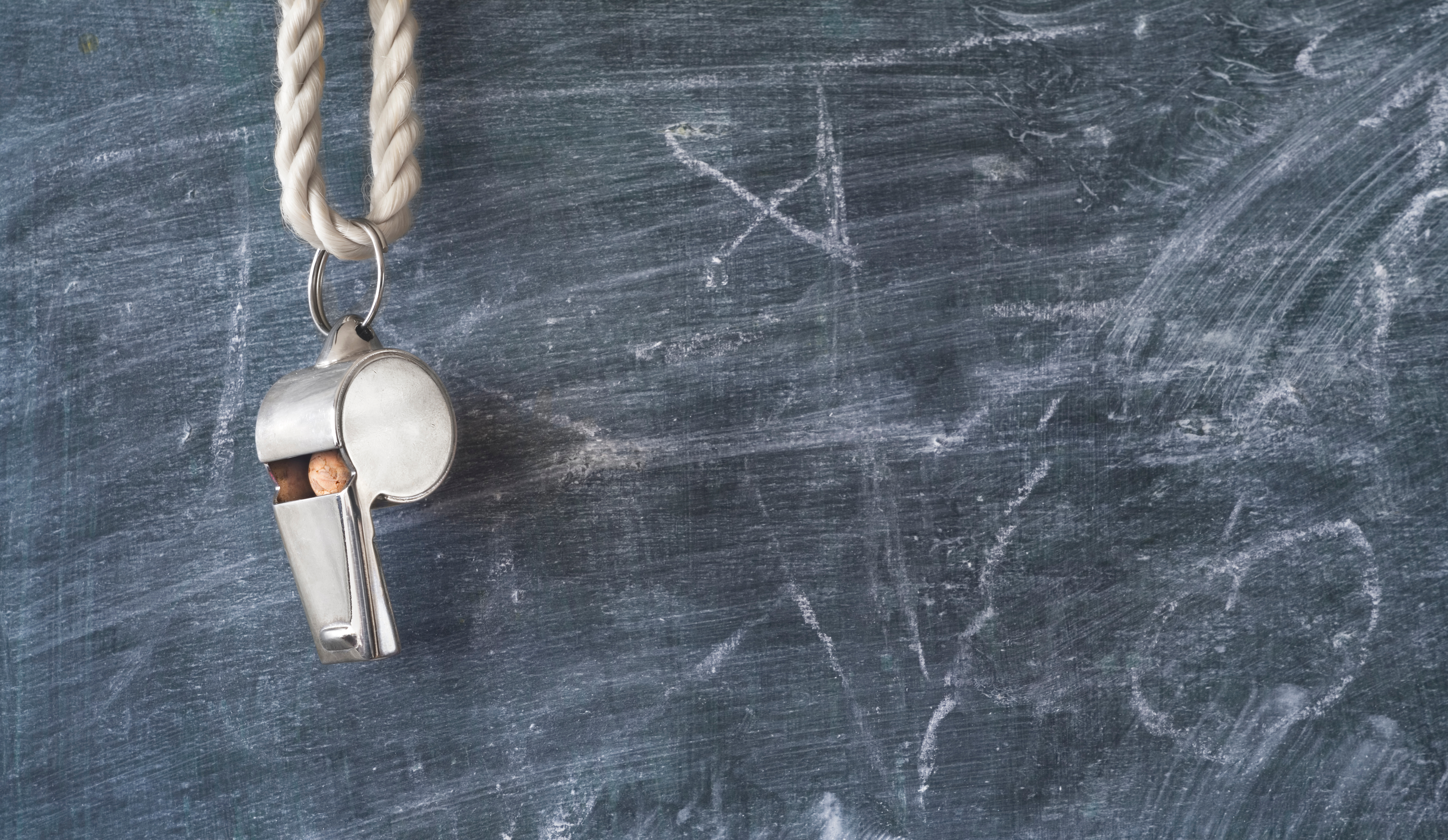 game whistle hanging in front of chalkboard